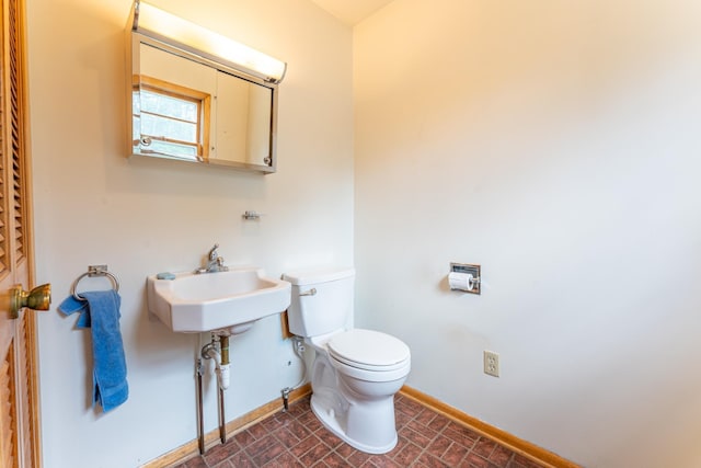 8702 Sock Lake Rd, Babbitt, MN 55706 - bathroom with toilet and baseboards