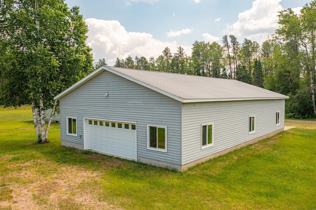 8702 Sock Lake Rd, Babbitt, MN 55706 - view of side of property with a lawn and a garage