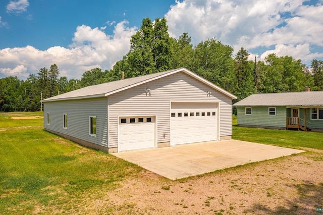 8702 Sock Lake Rd, Babbitt, MN 55706 - view of property exterior with a detached garage, an outdoor structure, and a yard