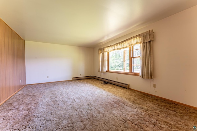 8702 Sock Lake Rd, Babbitt, MN 55706 - carpeted spare room featuring baseboard heating and wood walls