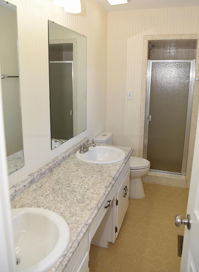 bathroom with tile patterned flooring, toilet, an enclosed shower, and vanity