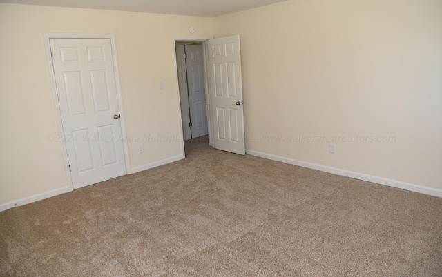 unfurnished bedroom featuring a closet and carpet floors