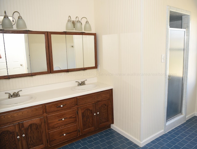 bathroom with vanity, tile patterned floors, and a shower with door