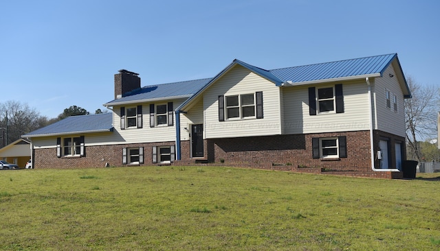 exterior space featuring a garage and a lawn