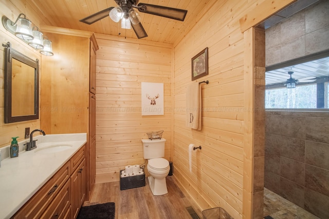 bathroom featuring hardwood / wood-style floors, vanity, wooden ceiling, and wooden walls