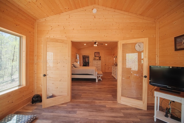 bedroom featuring wood ceiling, lofted ceiling, and wooden walls