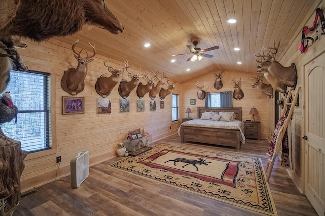 bedroom with wood walls, lofted ceiling, ceiling fan, wood-type flooring, and wood ceiling