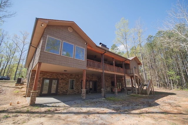 rear view of house with french doors, a patio, and central AC unit