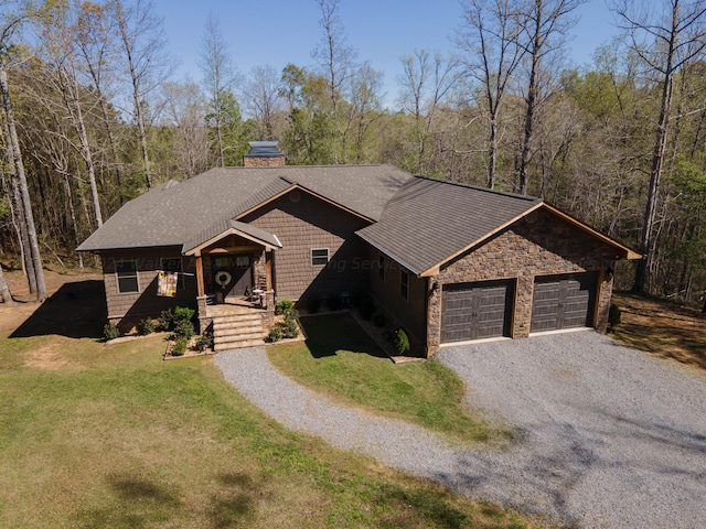 view of front of house featuring a garage and a front lawn