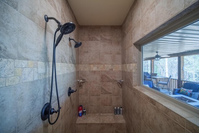 bathroom featuring ceiling fan and a tile shower