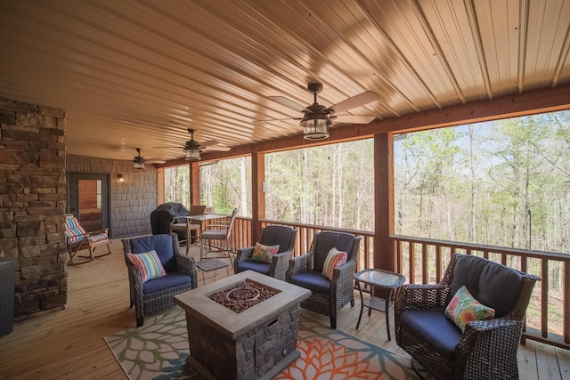 sunroom / solarium featuring ceiling fan and wooden ceiling