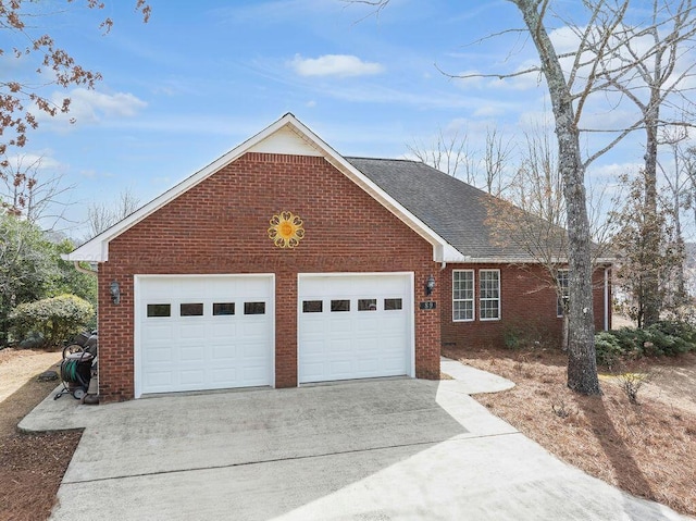 view of front facade featuring brick siding, driveway, an attached garage, and roof with shingles