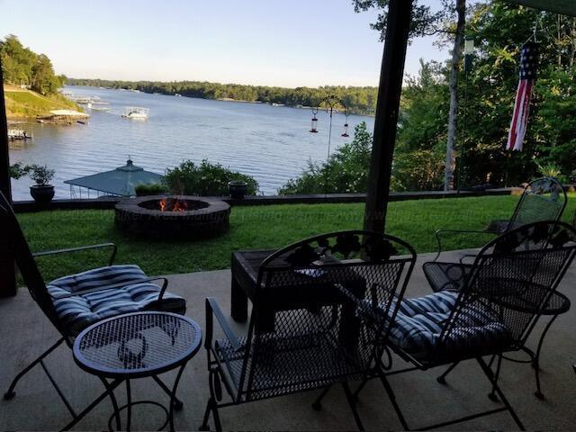 view of patio / terrace featuring a water view and an outdoor fire pit