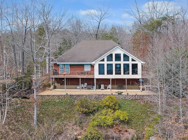 back of property featuring a deck, a patio, and stairway