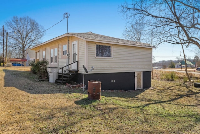 view of side of home with a lawn