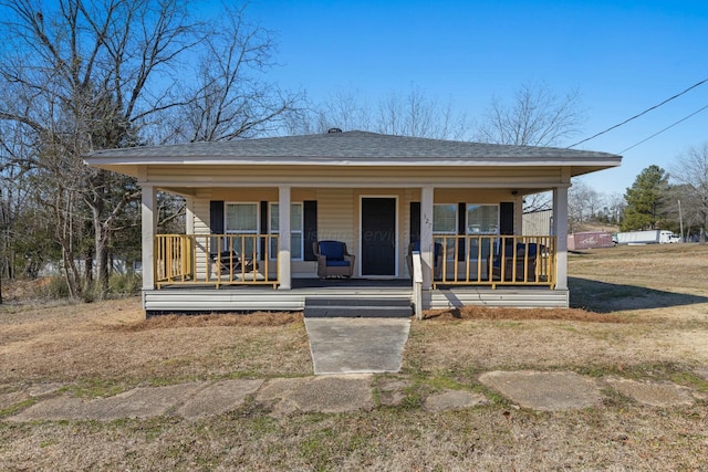 bungalow-style home with a porch and a front lawn