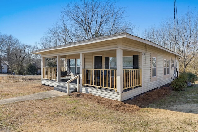 manufactured / mobile home with a porch and a front lawn