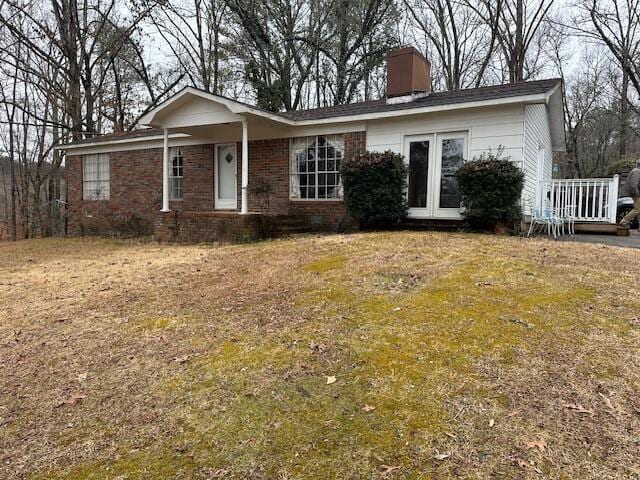 single story home featuring a front yard and french doors