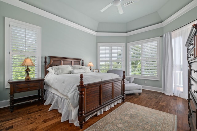 bedroom with multiple windows, ceiling fan, dark hardwood / wood-style flooring, and ornamental molding