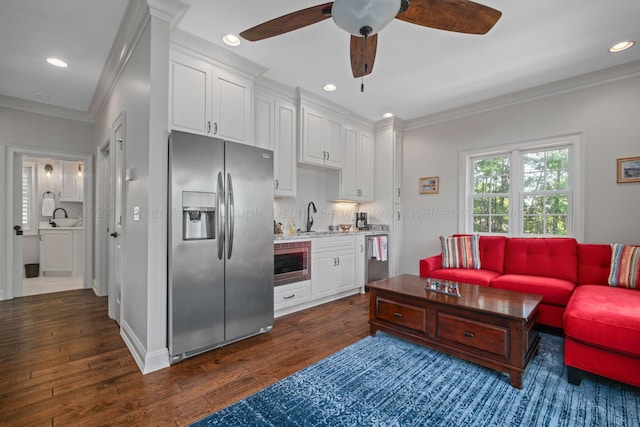 living room with ceiling fan, sink, dark hardwood / wood-style floors, and ornamental molding