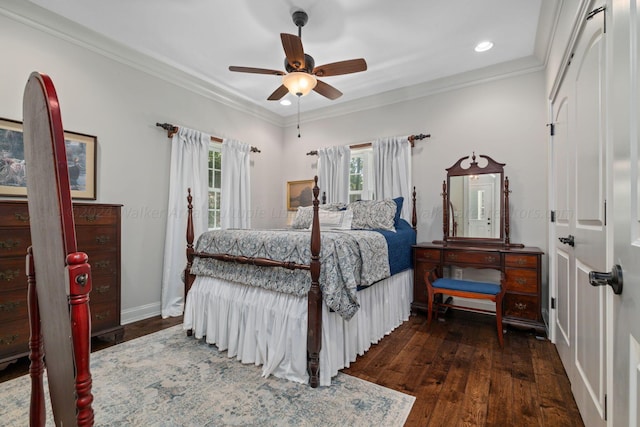 bedroom featuring dark hardwood / wood-style flooring, ceiling fan, and crown molding