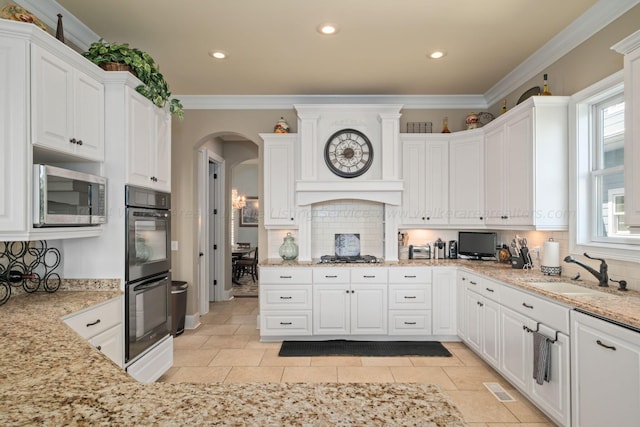 kitchen with crown molding, sink, white cabinets, and appliances with stainless steel finishes