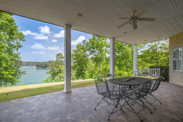 view of patio featuring ceiling fan and a water view