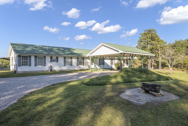 ranch-style house with a front yard and a carport