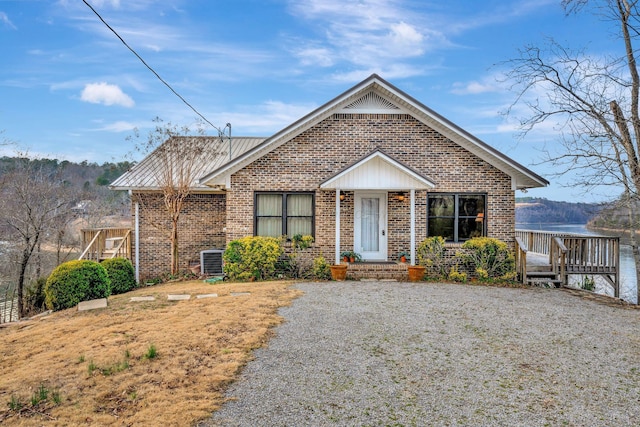 bungalow with a wooden deck and central AC unit