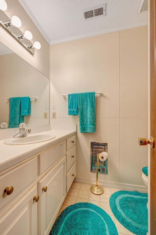 bathroom with vanity, crown molding, tile patterned floors, and a textured ceiling