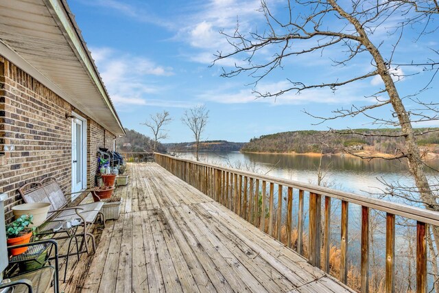 wooden terrace featuring a water view