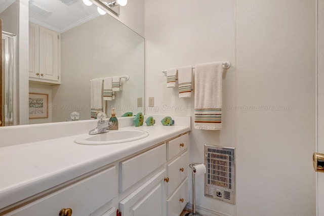 bathroom with vanity, ornamental molding, and heating unit