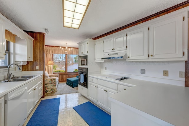 kitchen with sink, black oven, white cabinetry, white dishwasher, and electric cooktop