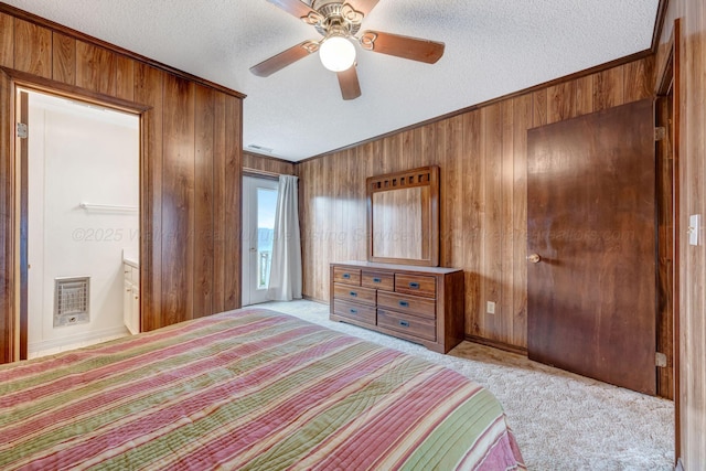 carpeted bedroom featuring heating unit, ceiling fan, a textured ceiling, and wood walls