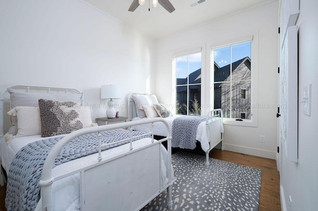 bedroom with ceiling fan and dark hardwood / wood-style floors