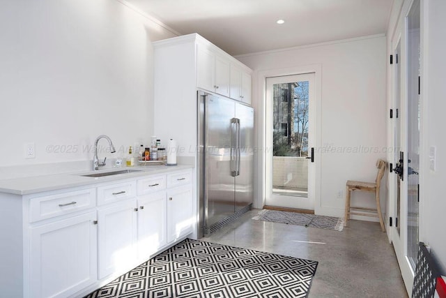 bathroom featuring ornamental molding, vanity, and concrete flooring