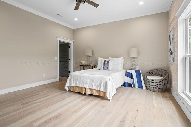 bedroom with light wood-type flooring, crown molding, and ceiling fan