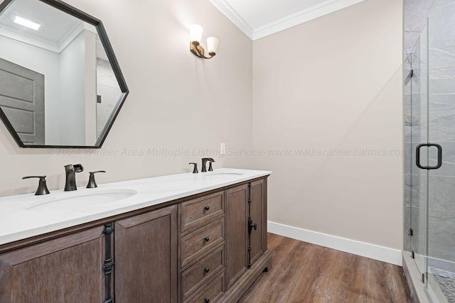 bathroom featuring hardwood / wood-style flooring, vanity, ornamental molding, and walk in shower