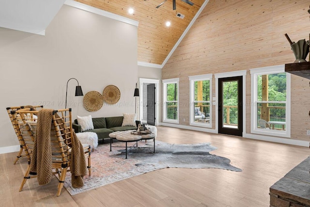 living room with wooden ceiling, high vaulted ceiling, light wood-type flooring, and a healthy amount of sunlight