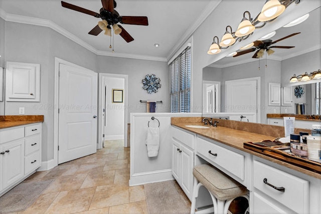 bathroom featuring crown molding, ceiling fan, and vanity