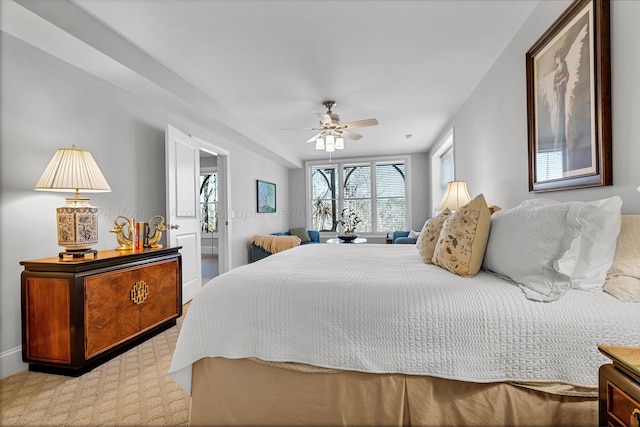 bedroom with ceiling fan and light carpet