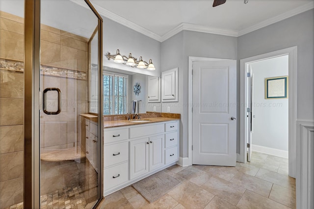 bathroom with ornamental molding, vanity, ceiling fan, and walk in shower