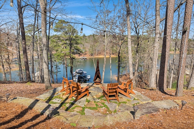 view of patio with a water view and a boat dock