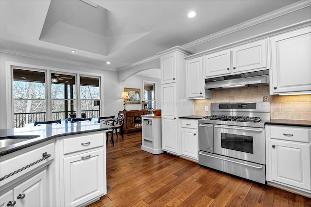 kitchen featuring ornamental molding, range with two ovens, and white cabinets