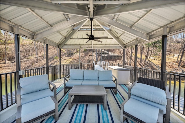 deck featuring a gazebo, ceiling fan, and outdoor lounge area