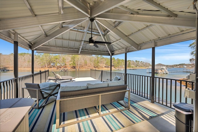 wooden deck featuring a gazebo, a water view, an outdoor hangout area, and ceiling fan