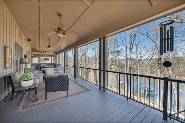 wooden deck with an outdoor hangout area and ceiling fan