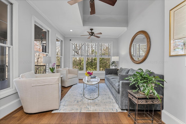 living room featuring crown molding, ceiling fan, and hardwood / wood-style floors