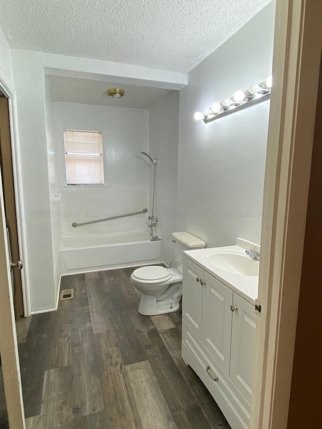 full bathroom with vanity,  shower combination, toilet, and wood finished floors