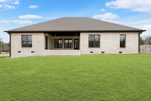 rear view of property with a lawn